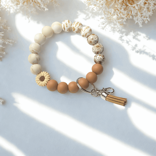 Beaded bracelet with a tassel charm on a light background