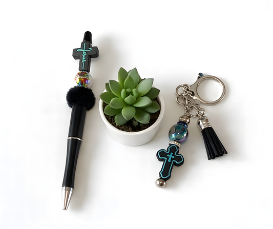 Pen, small plant, and keychain with cross design on a white background