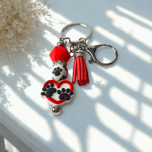 Keychain with paw print design on a light surface