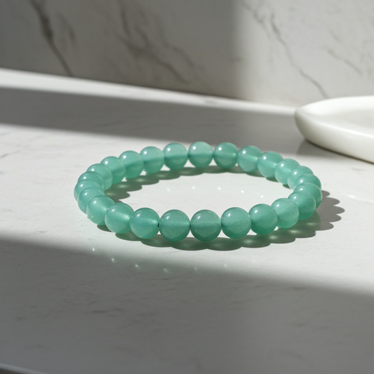 Green beaded bracelet on a white surface