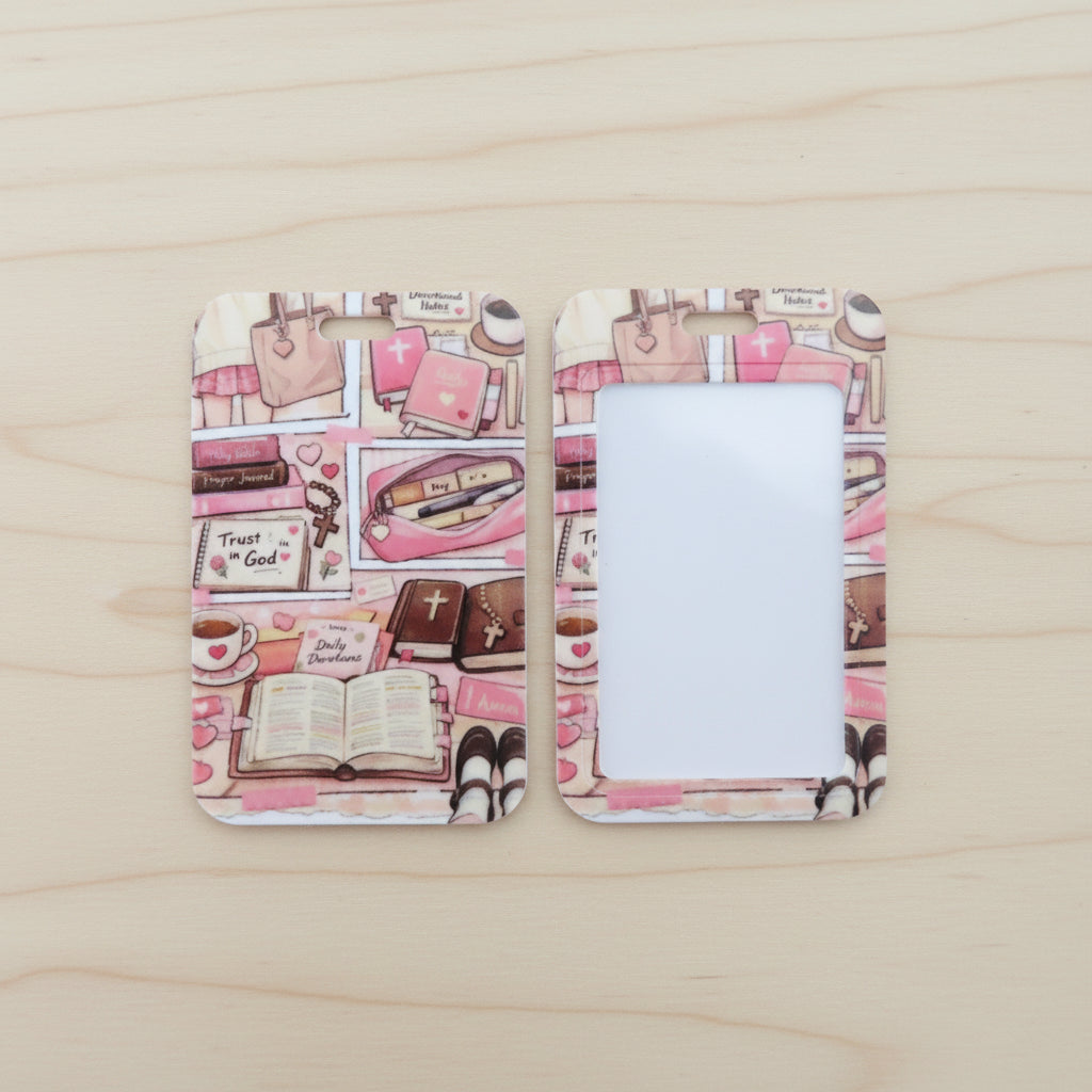 Two rectangular picture frames with rounded corners displayed side by side on a light wood surface. The frames feature a pink and white collage-style illustration with books, handbags, hearts, and small decorative motifs.