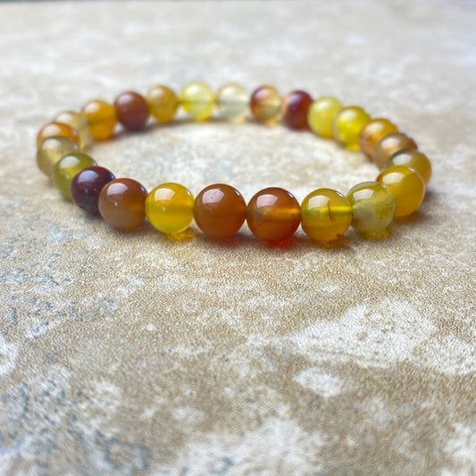 Multicolored beaded bracelet on a textured surface