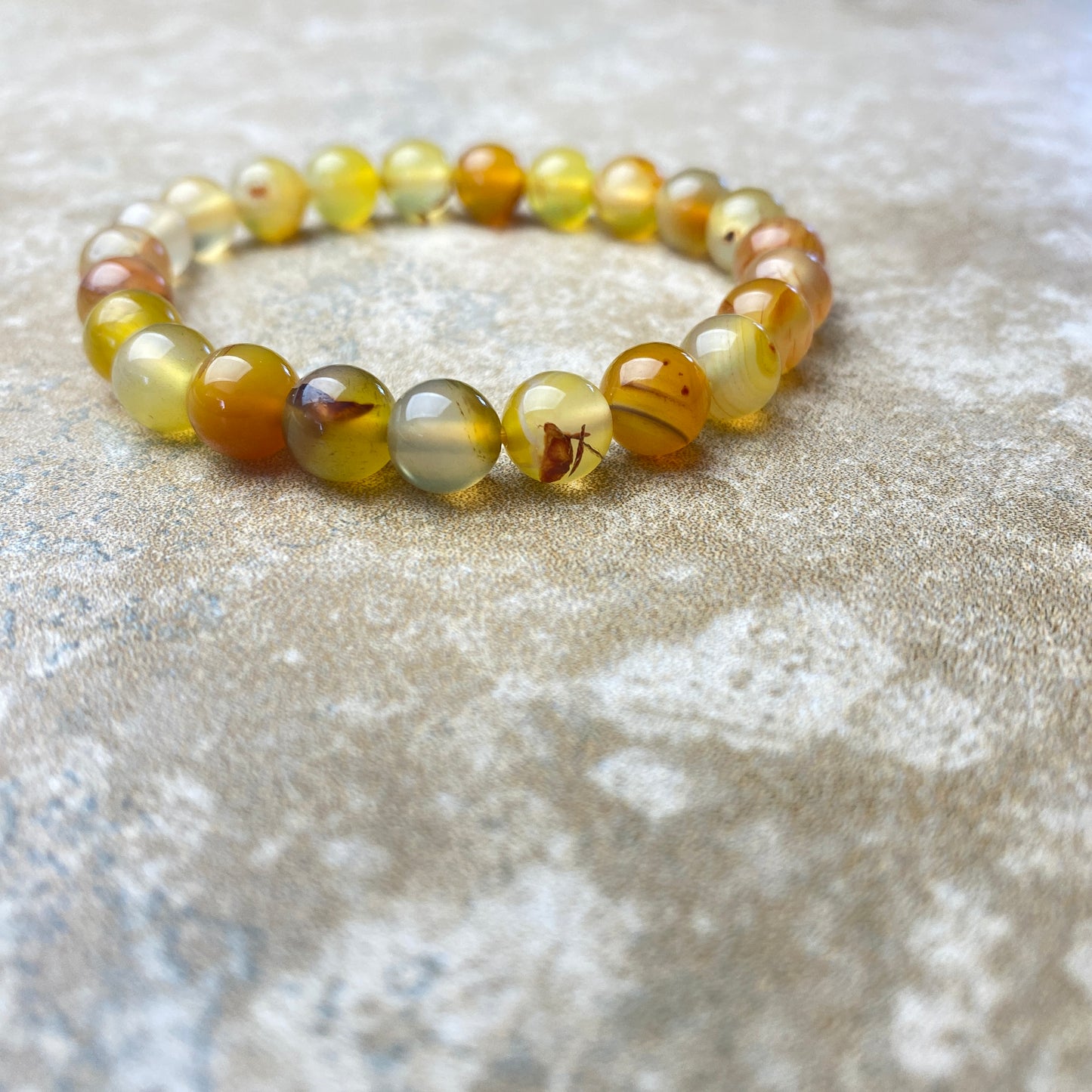 Beaded bracelet with multicolored beads on a textured surface