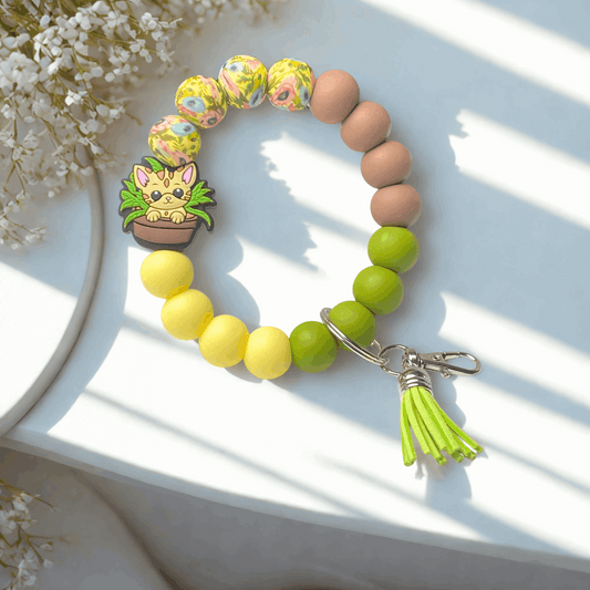 Colorful beaded bracelet with a tassel charm on a white surface