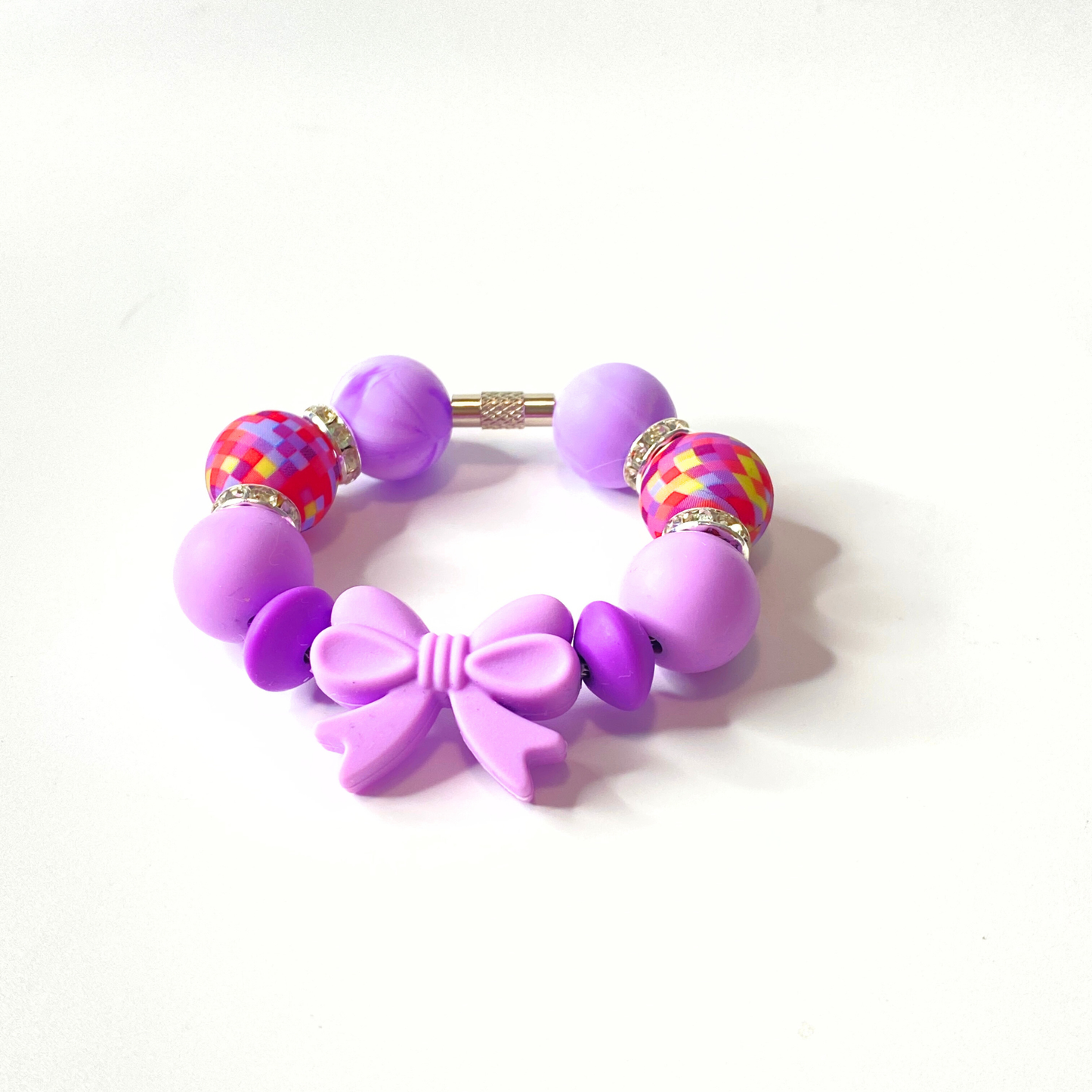 Purple bracelet with colorful beads on a white background