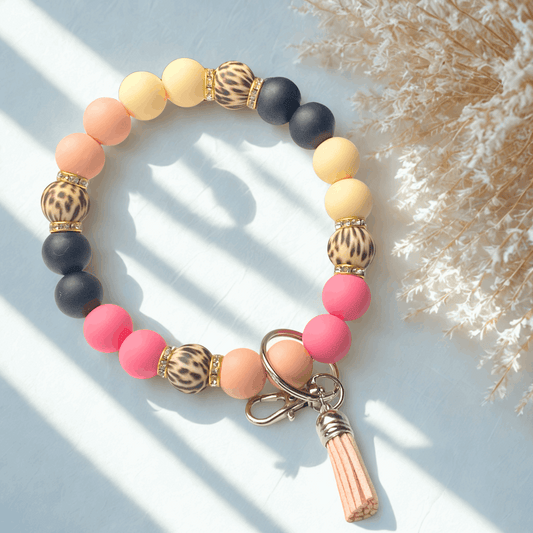 Colorful beaded bracelet with keychain on a light background