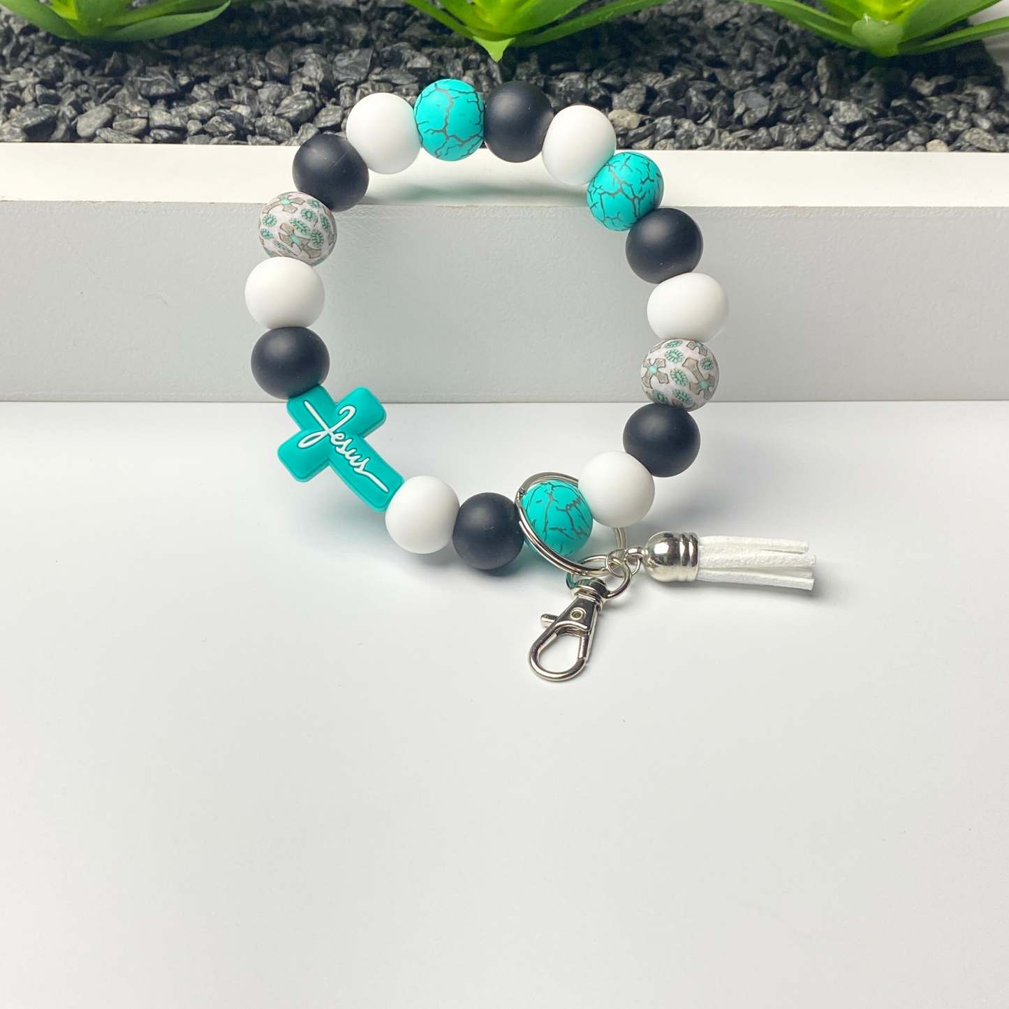 Bracelet with blue, black, and white beads on a white surface