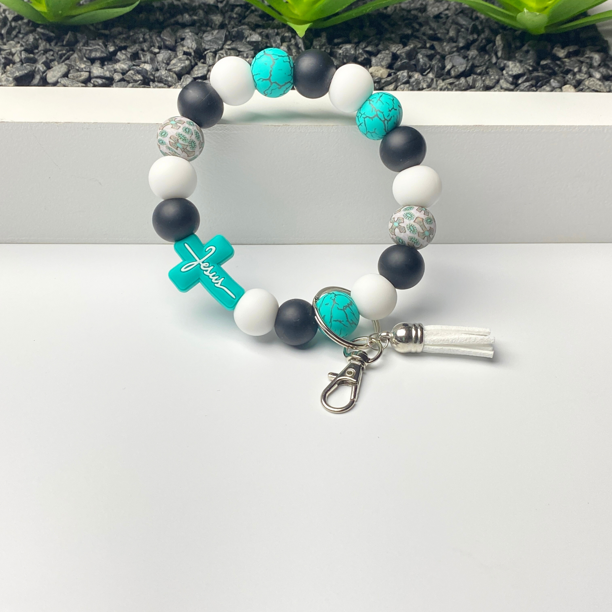 Bracelet with blue, black, and white beads on a white surface