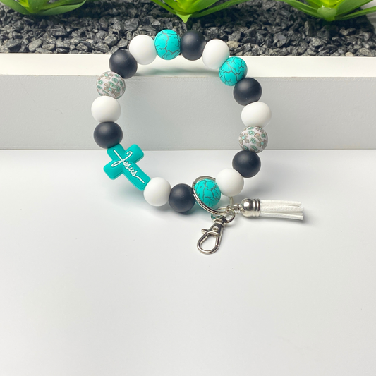 Bracelet with blue, black, and white beads on a white surface