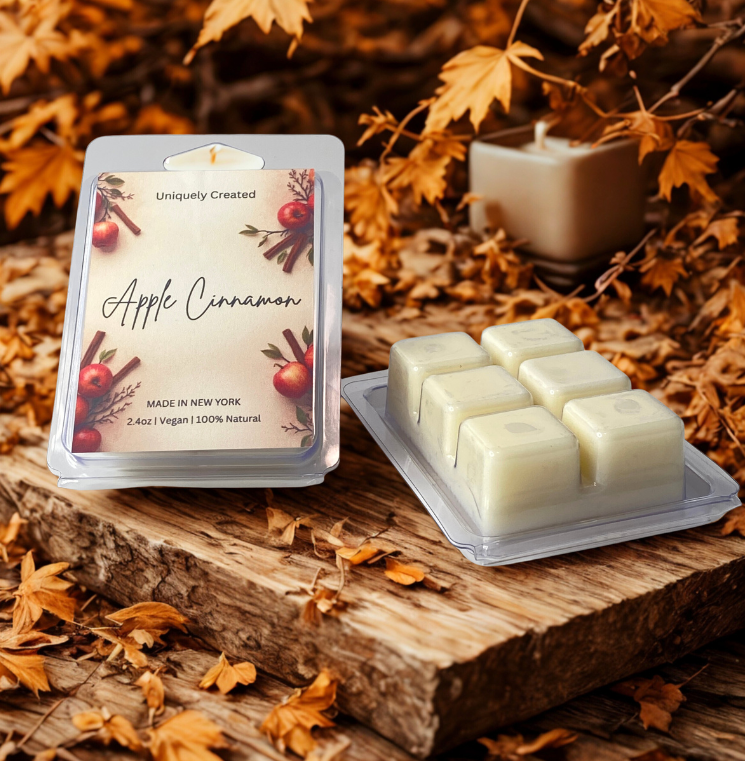 Apple cinnamon wax melts packaging with wax melts on a wooden surface with autumn leaves.