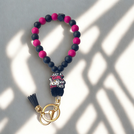 Beaded keychain with tassel and charm on a light background