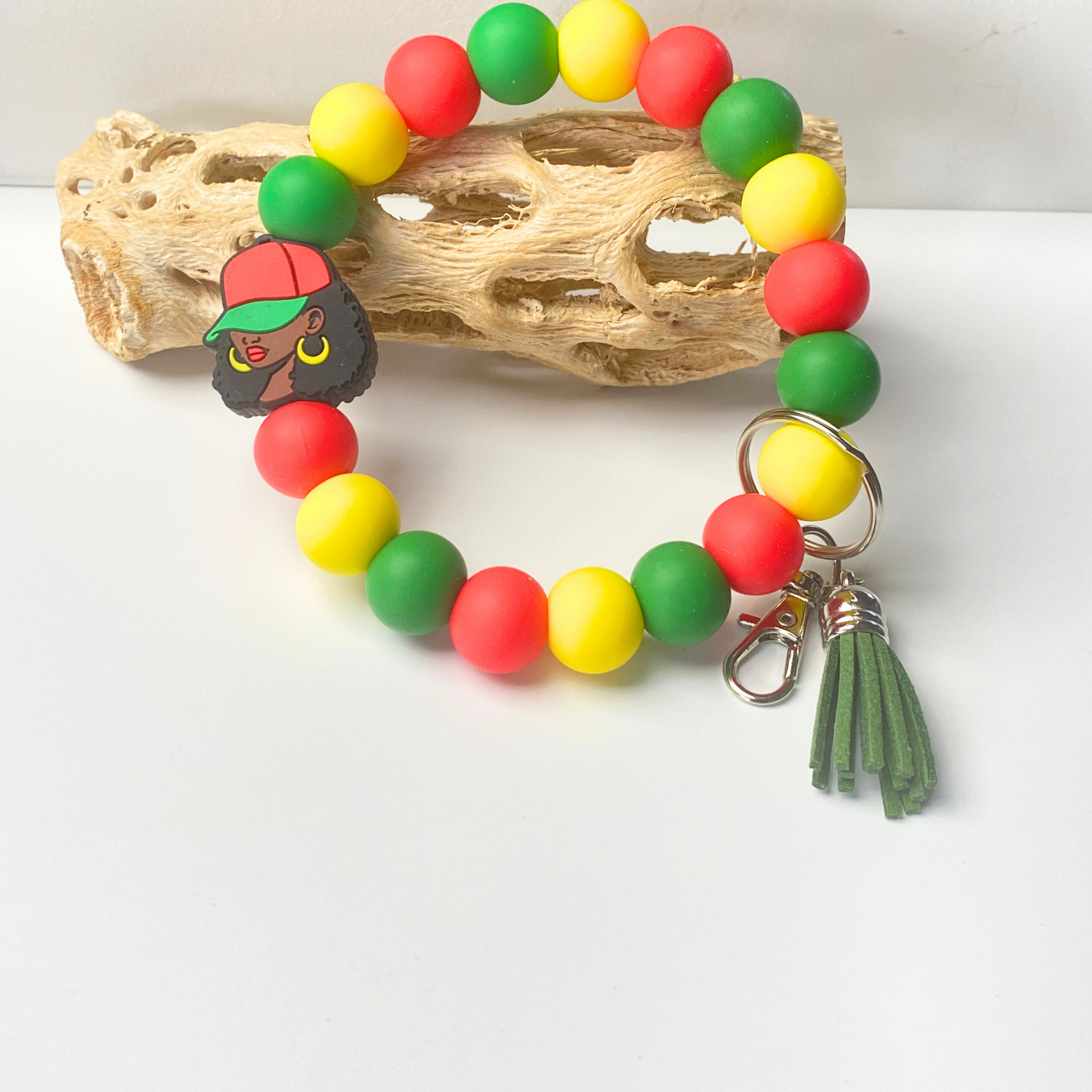 Colorful beaded bracelet with a keychain and tassel on a white background