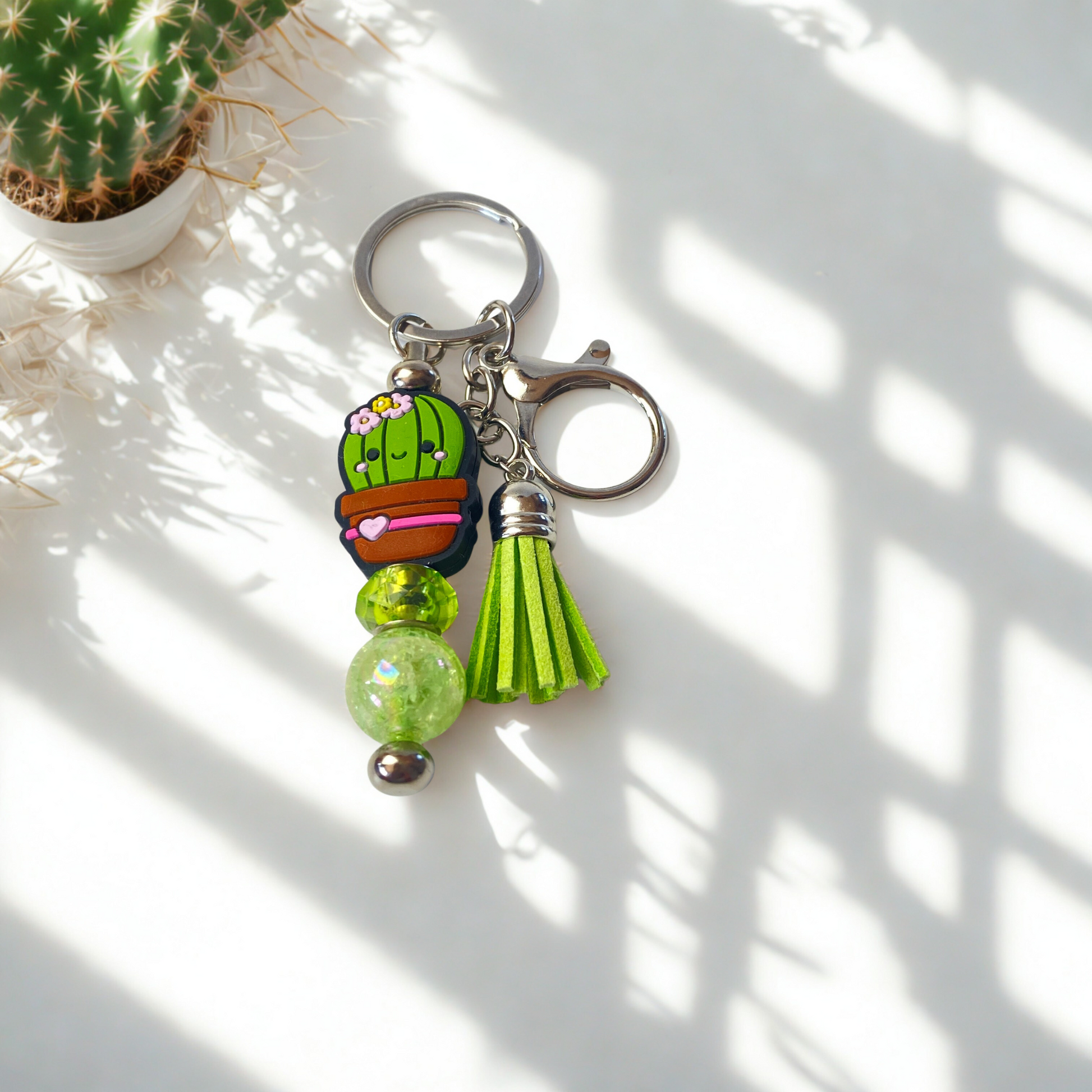 Keychain with cactus charm and tassel on a light background