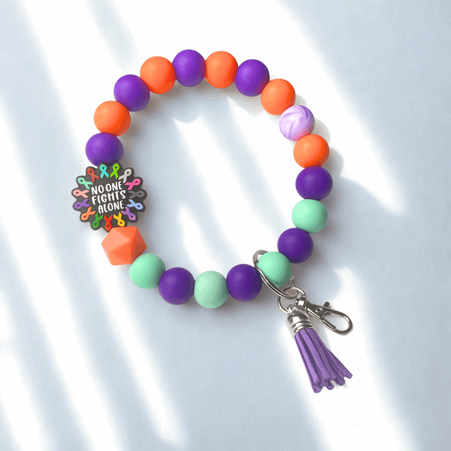 Colorful beaded bracelet with a keychain on a white background