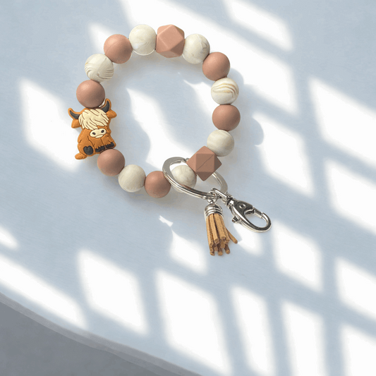 Beaded keychain with a small animal charm on a light background