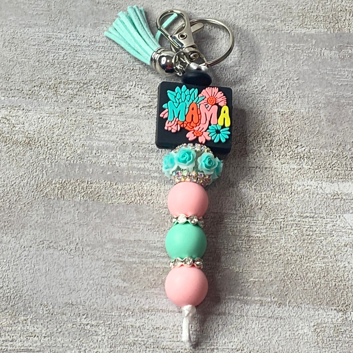Keychain with beads and tassel on a gray background