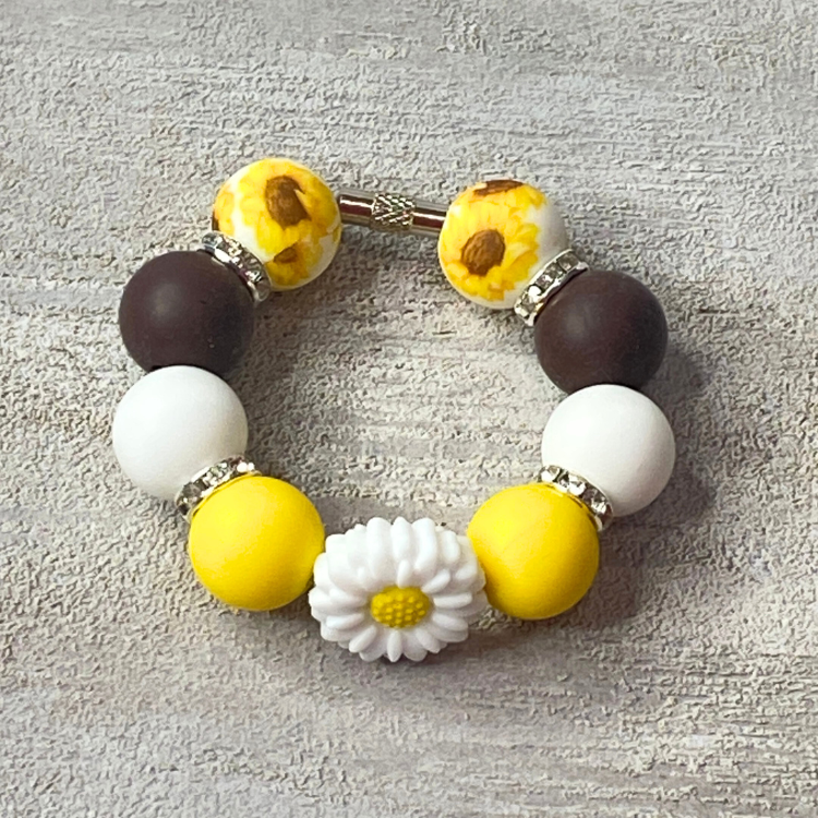 Bracelet with colorful beads on a textured gray background