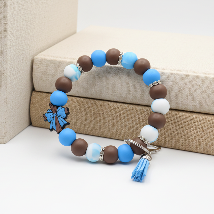 Beaded bracelet with blue, brown, and white beads on a white surface with green plants in the background