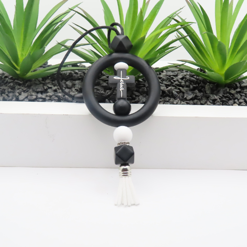 Black and white beaded keychain with tassel on a white background