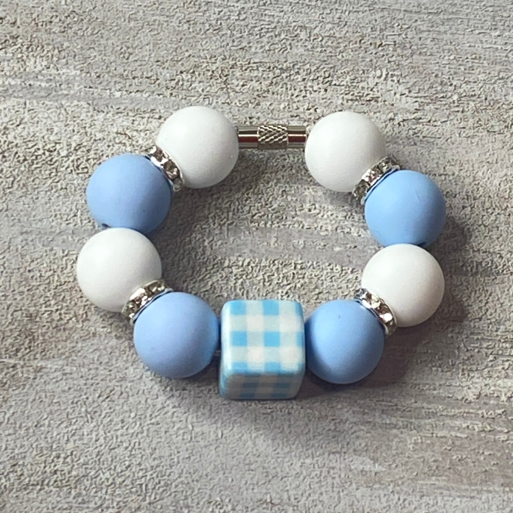 Bracelet with blue and white beads on a textured surface