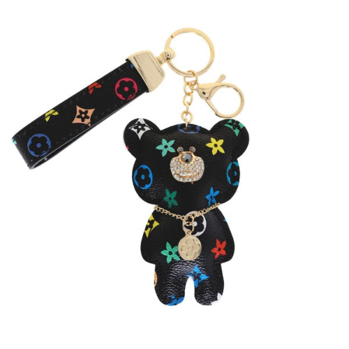 Black bear-shaped keychain with colorful designs on a white background
