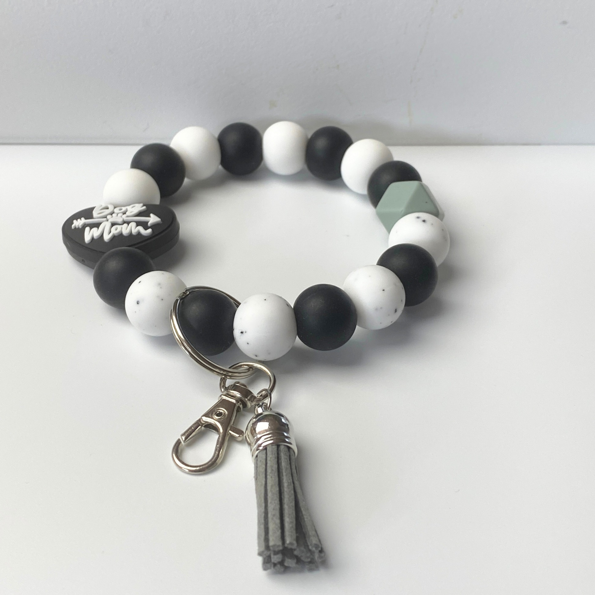 Beaded bracelet with keychain and tassel on a white background