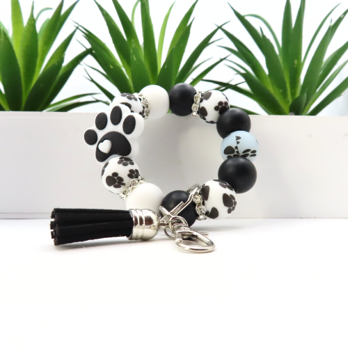 Bracelet with paw print design on beads against a white background