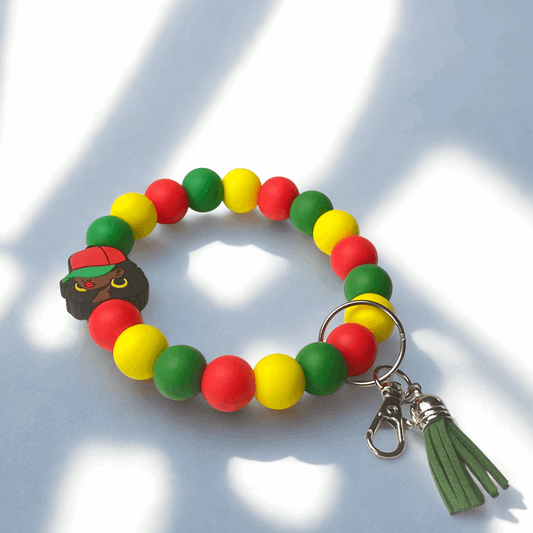 Colorful beaded bracelet with a keychain and tassel on a light background