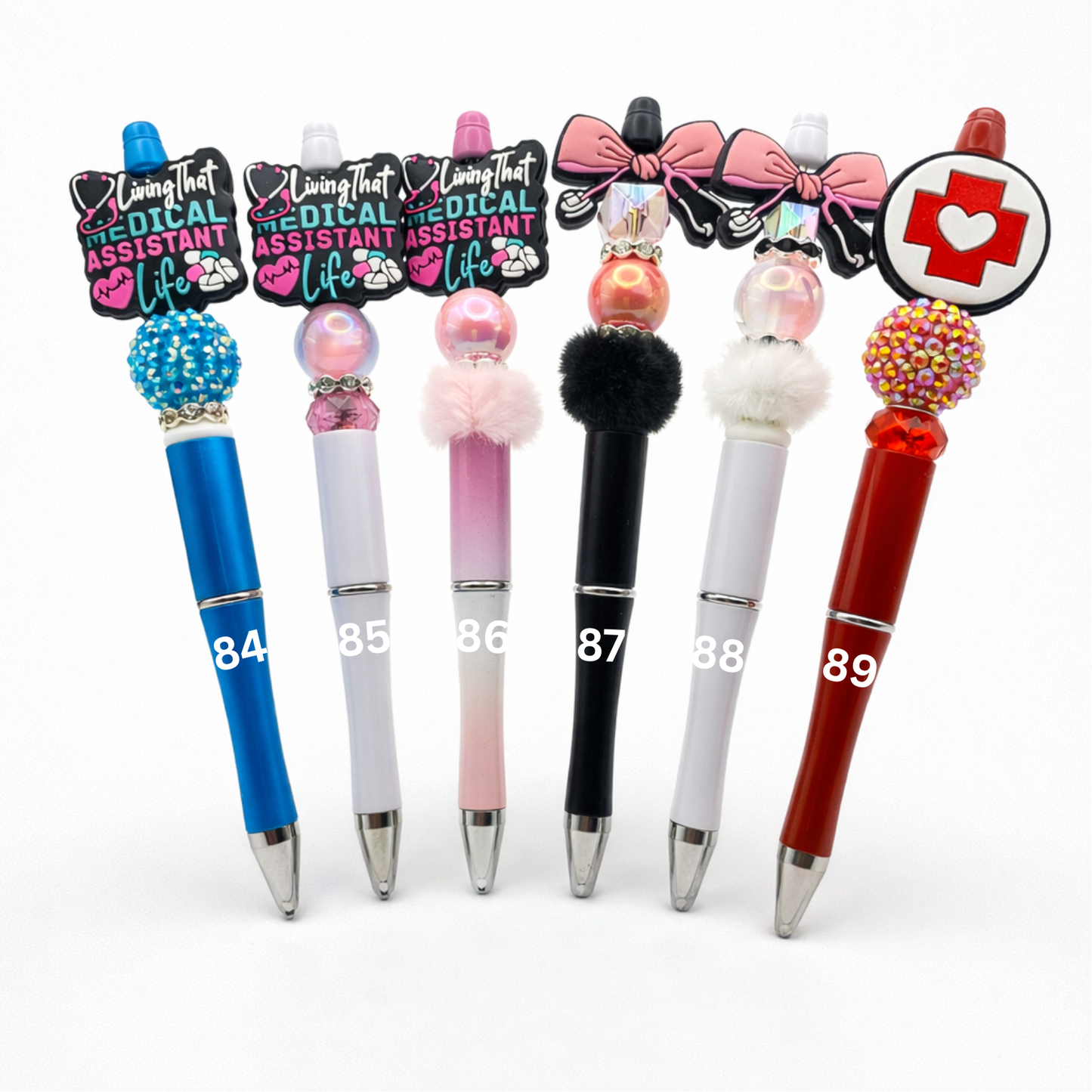 Set of decorative pens with various designs and colors on a white background