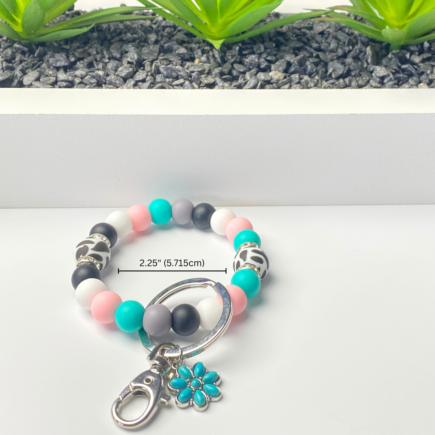 Beaded keychain with a measurement label on a white background