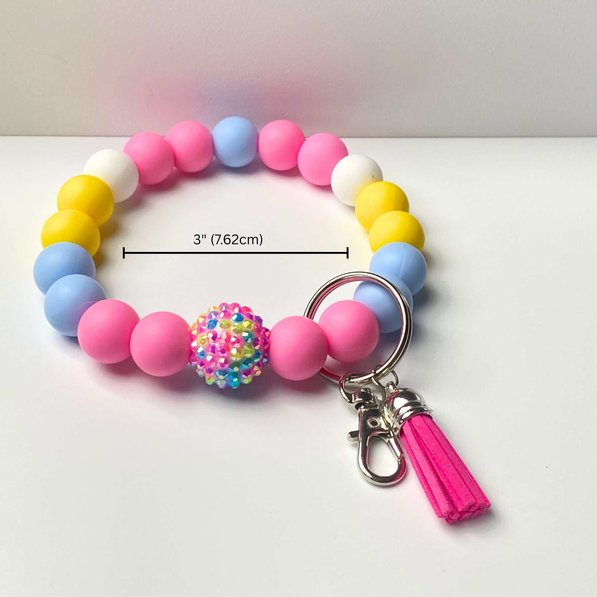 Colorful beaded keychain with a tassel on a white background