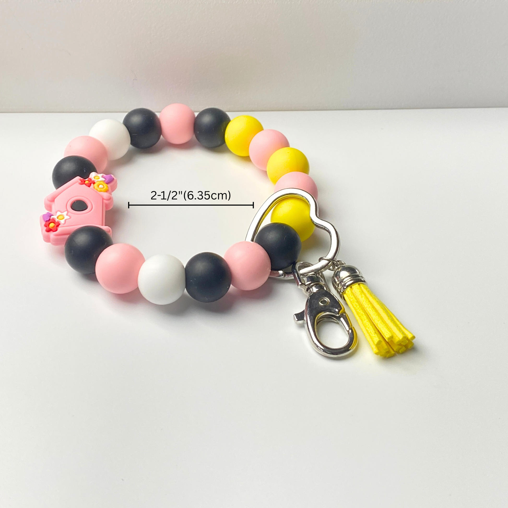 Colorful beaded keychain with a tassel on a white background