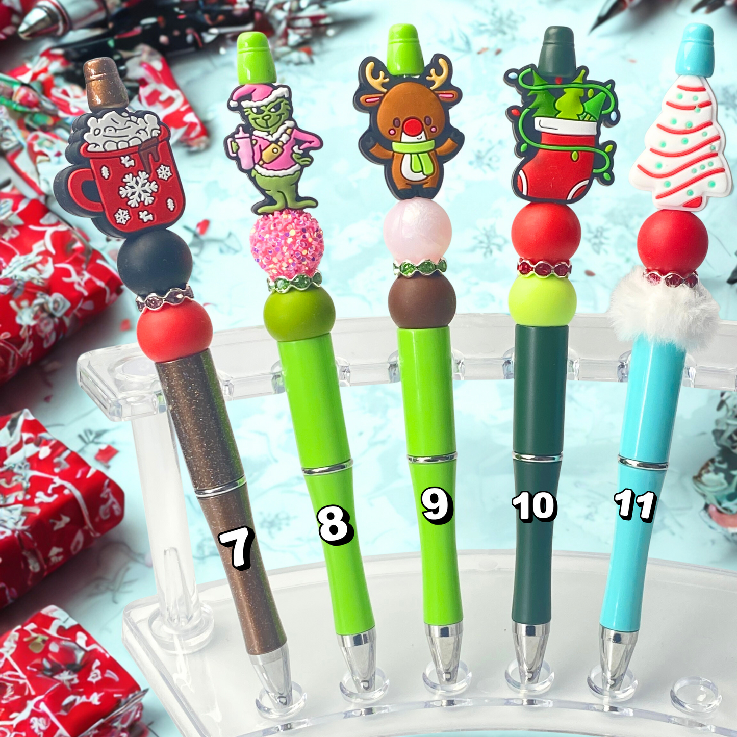 Set of colorful pens with decorative tops on a festive background