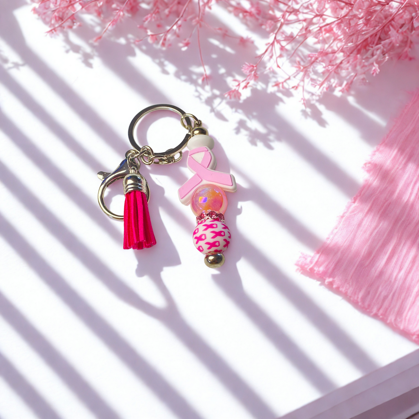 Pink keychain with tassel on a white background