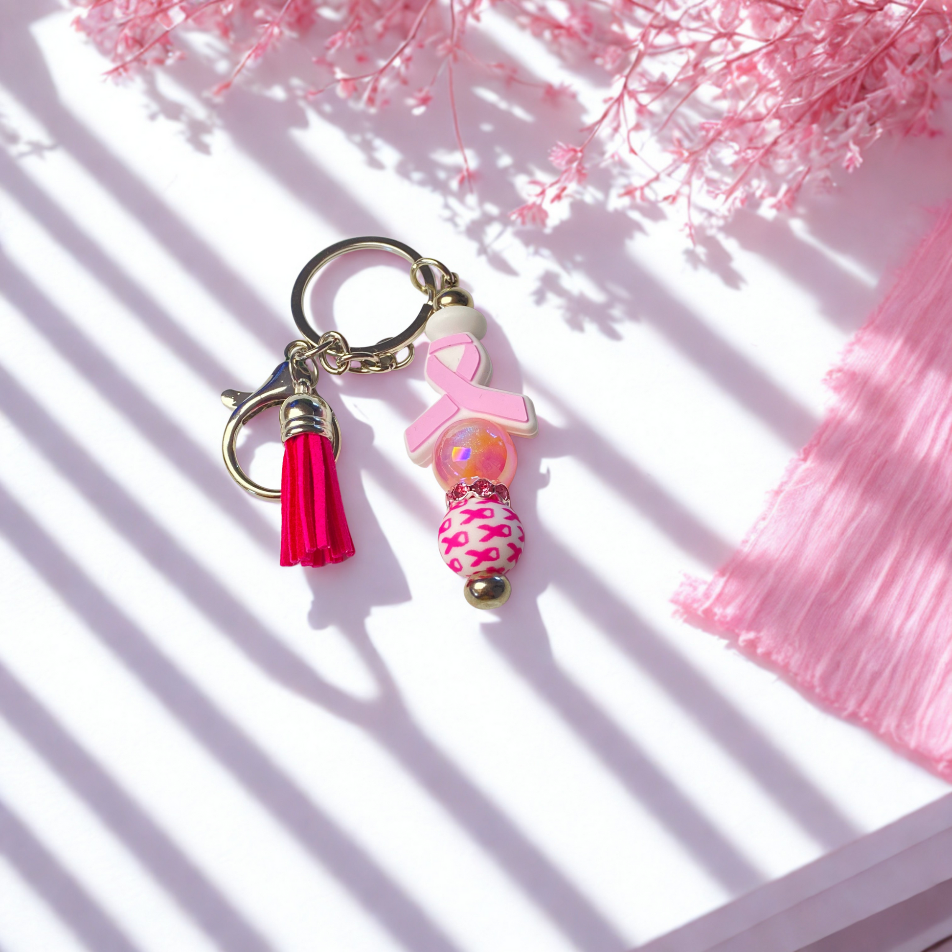 Pink keychain with tassel on a white background
