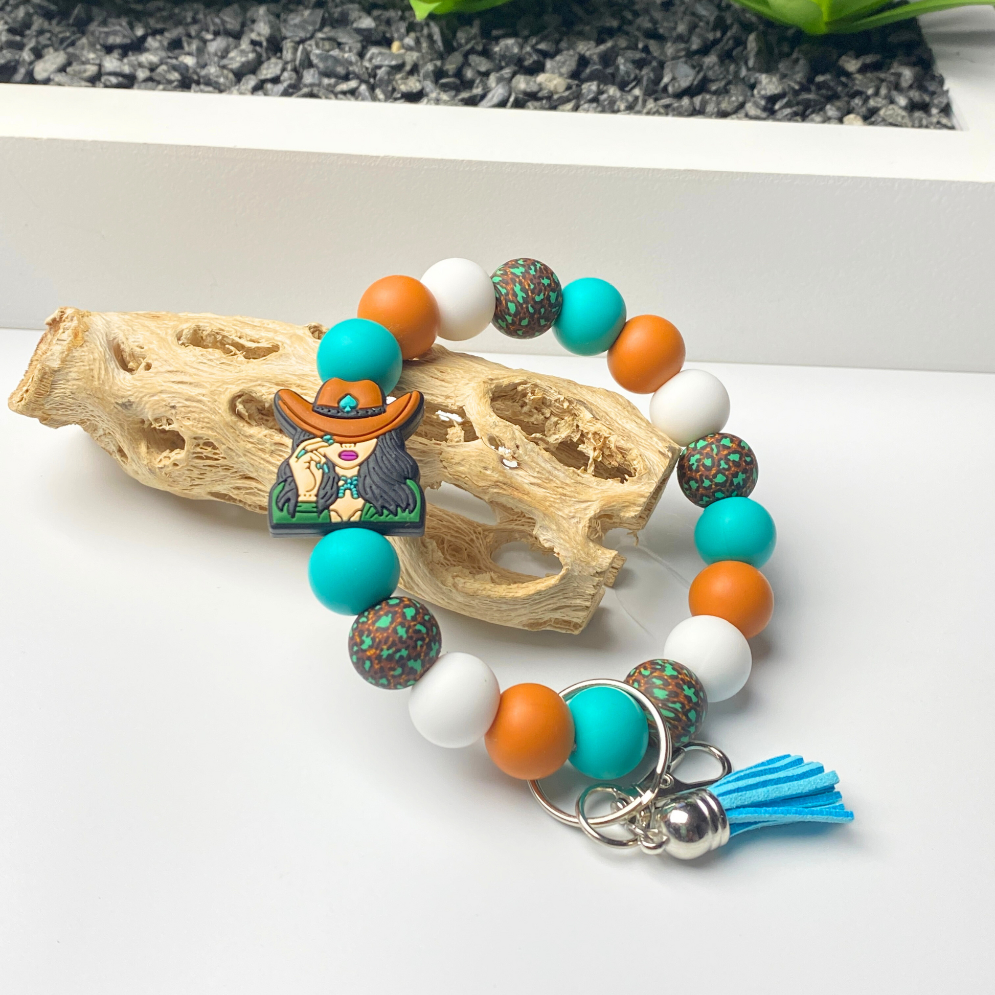 Colorful beaded bracelet with charms on a white surface