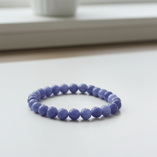 Purple beaded bracelet on a light surface with a blurred background