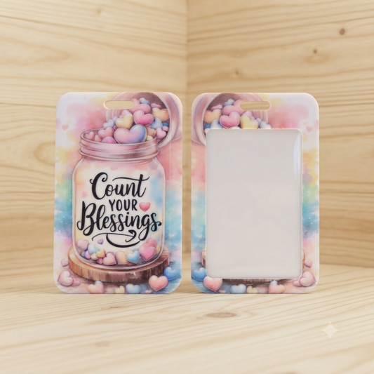 A phone case shown from both front and back views, featuring a pastel watercolor design with a mason jar filled with pink, blue, and yellow heart candies and the phrase 'Count Your Blessings' on the front.