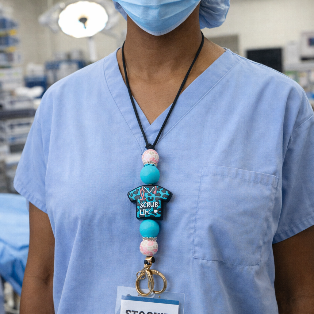 Person wearing blue scrubs with a decorative lanyard in a medical setting