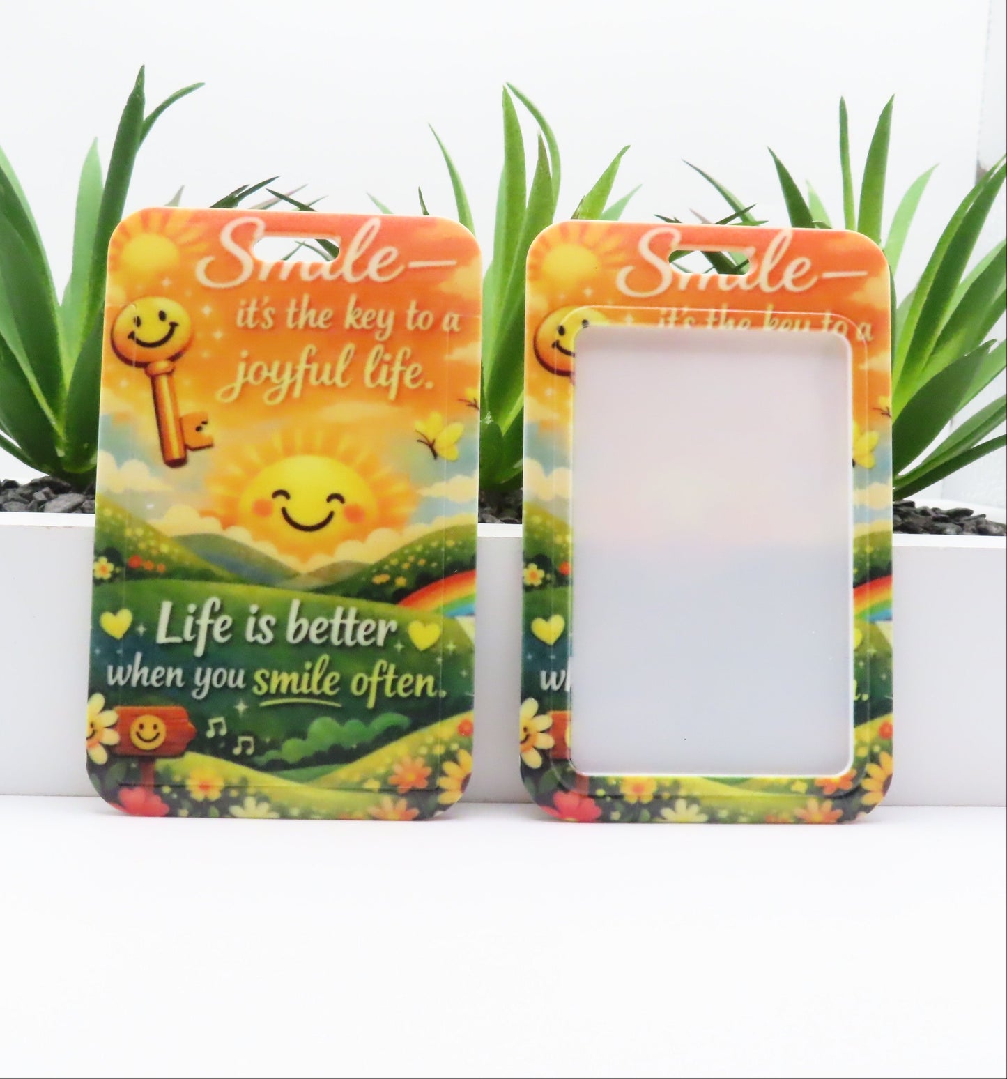 Two decorative picture frames with motivational quotes and smiley faces on a white background.