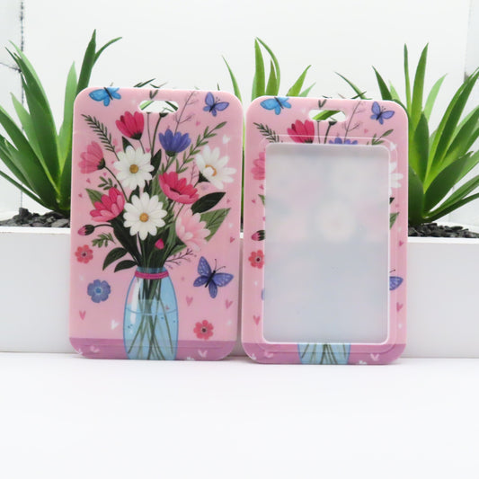 Two pink floral phone cases with a vase of flowers and butterflies on a white background.