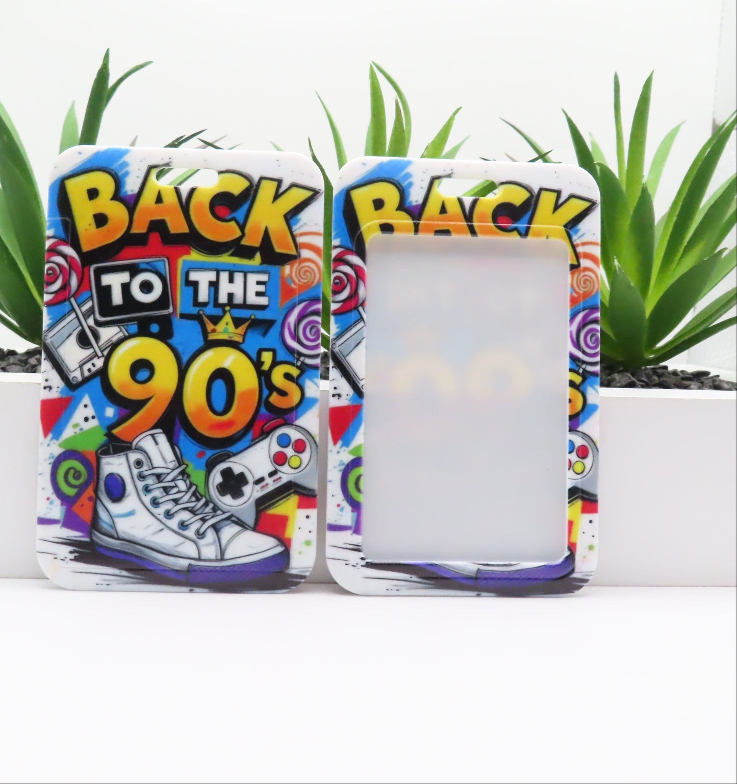Phone case with 'Back to the 90's' design featuring colorful graphics and text.