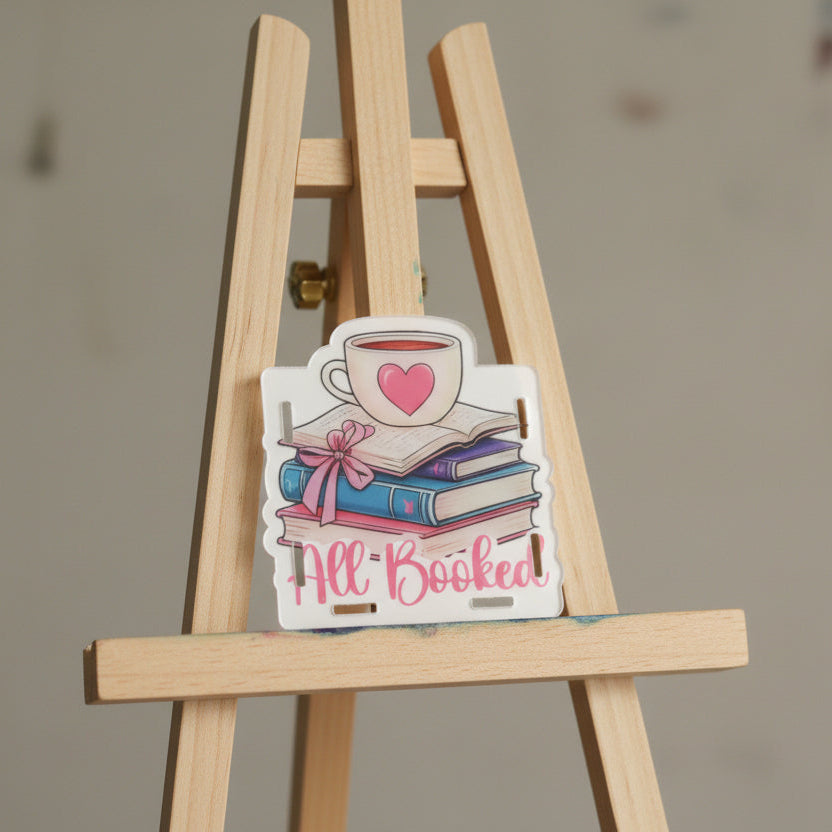Sticker with books, a cup of coffee, and a heart on a white background