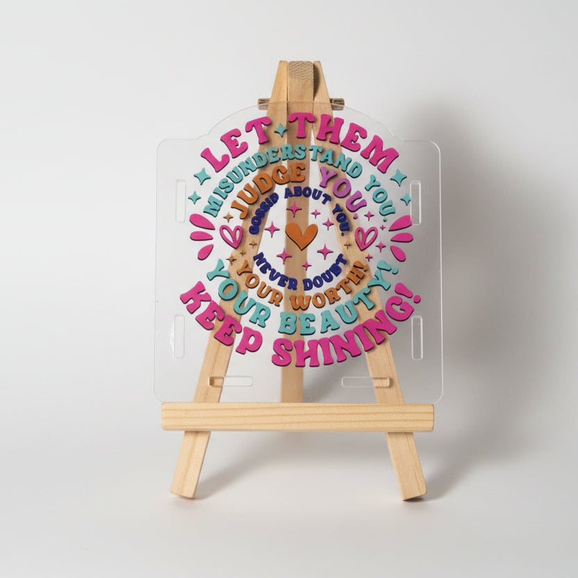 Decorative plate with motivational quote in colorful letters on a white background