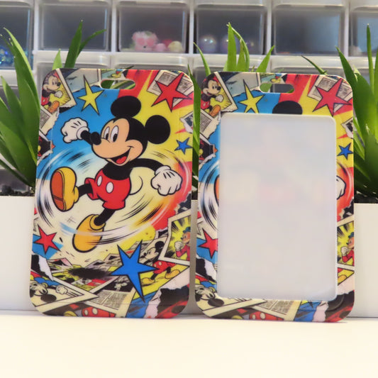 Colorful phone case with Mickey Mouse design on a white surface with green plants in the background.