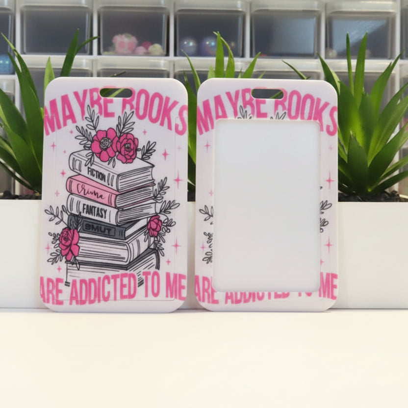 Phone case with book design and text 'Maybe books are addicted to me' on a white background.