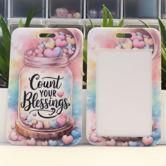 Phone case with 'Count Your Blessings' text and colorful design on a white surface.