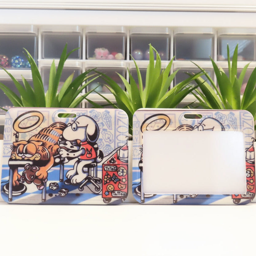 Two phone cases with cartoon designs on a white surface with plants in the background