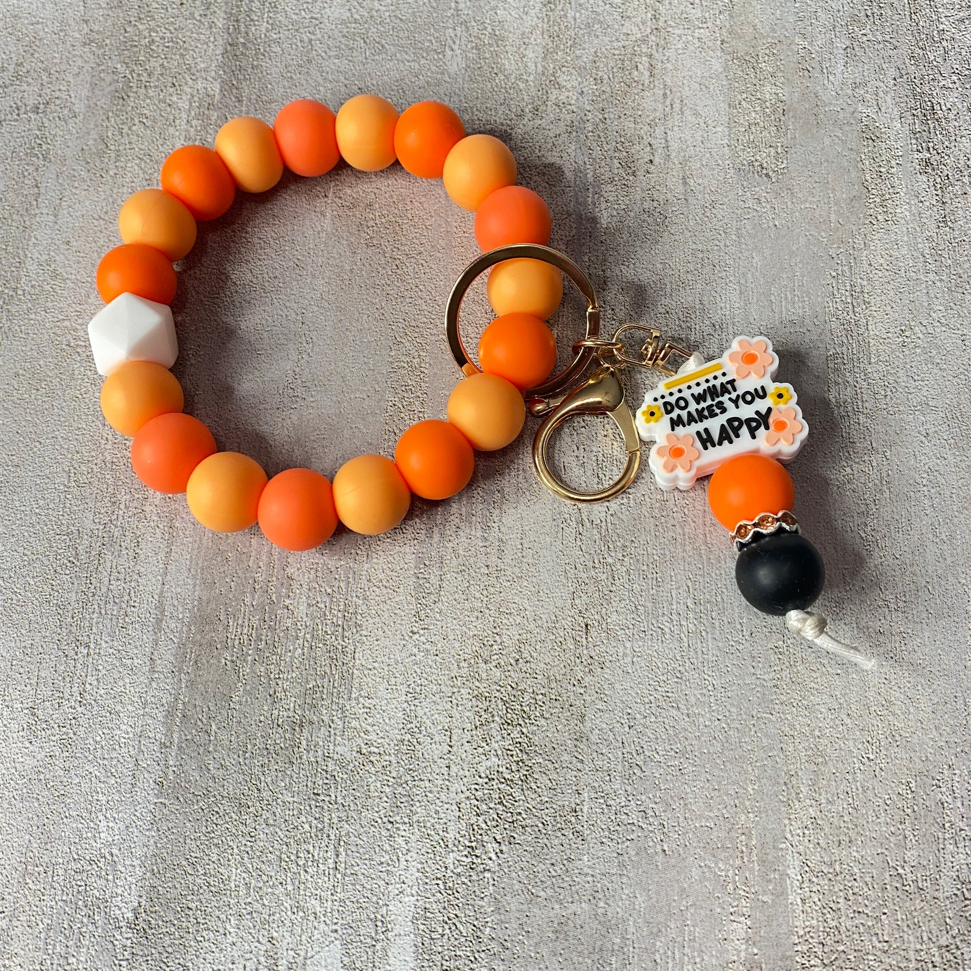 Beaded keychain with colorful beads on a gray textured background