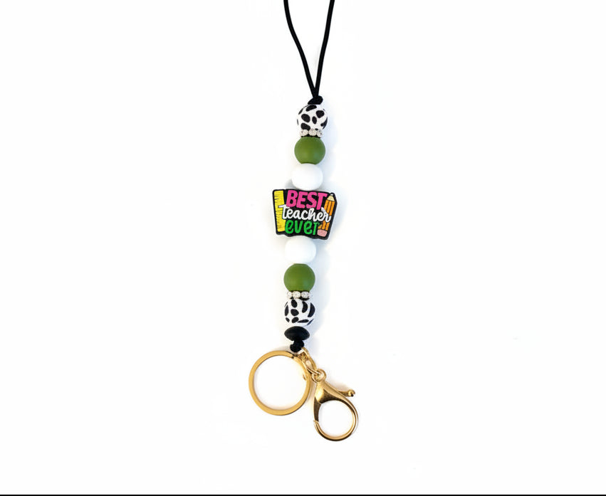 Lanyard with beads and a tag saying 'Best Teacher Ever' on a light gray background